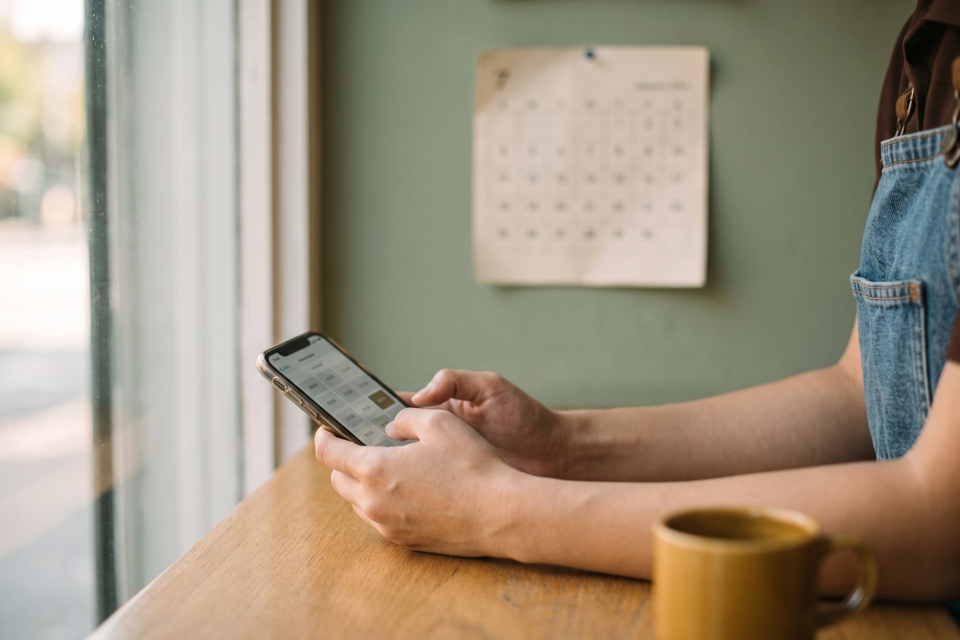 Hands picking a time slot on a phone booking screen